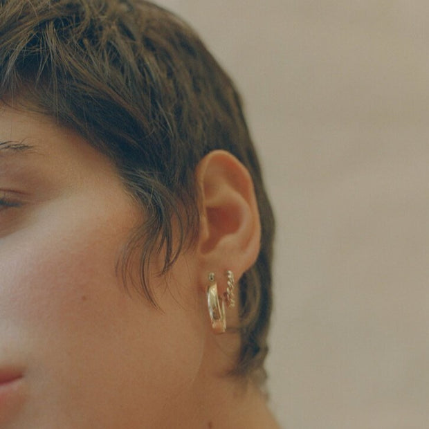 Close up of model wearing Laura Lombardi Mini Band Earrings
